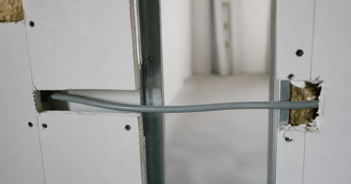 fil electrique traverse horizontalement interieur cloison placo blanche