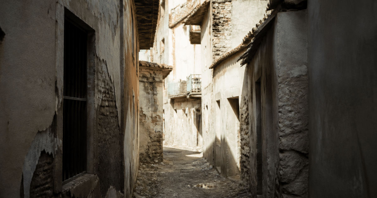 Rue urbaine avec immeubles délabres et passages sombres entre batiments